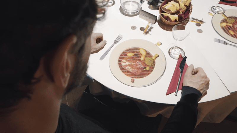 Man looking at projected miniature chef