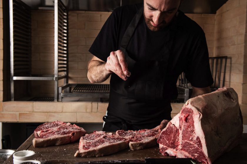 Chef tenderising steak in Bistecca restaurant Sydney