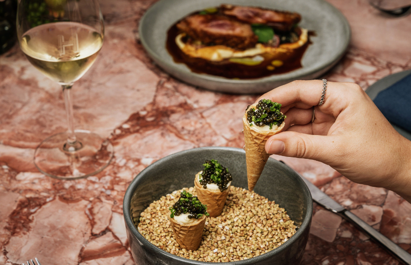 Caviar Cornetto being selected, an exclusive dish at Humphrey's Hotel & Hatch Restaurant.