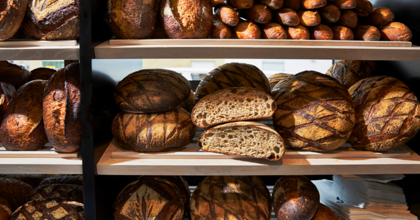 French bakery Loulou with display shelving unit of freshly baked bread.