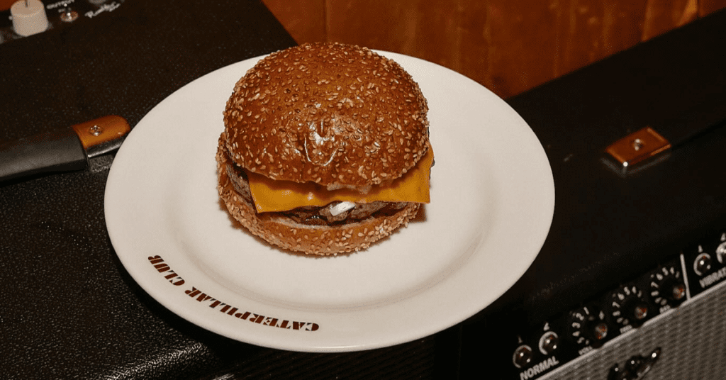 Caterpillar Club Happy Hour - burger on branded plate