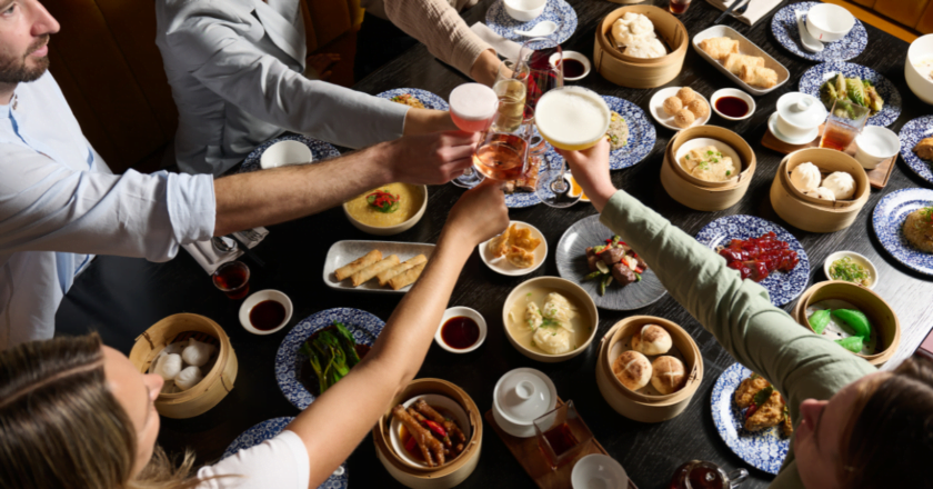 Drinks clinking over Jinja Bottomless Yum Cha