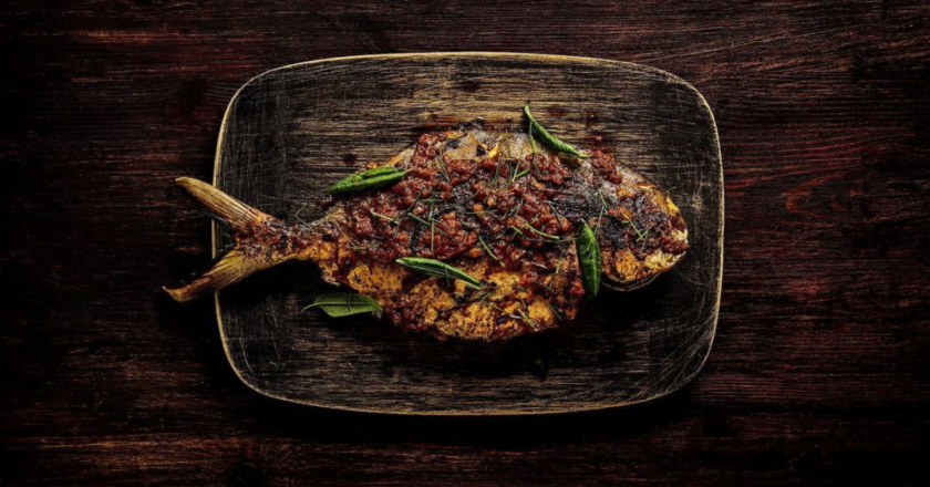 Ogni whole fish with assam pedas butter and Australian native greens.