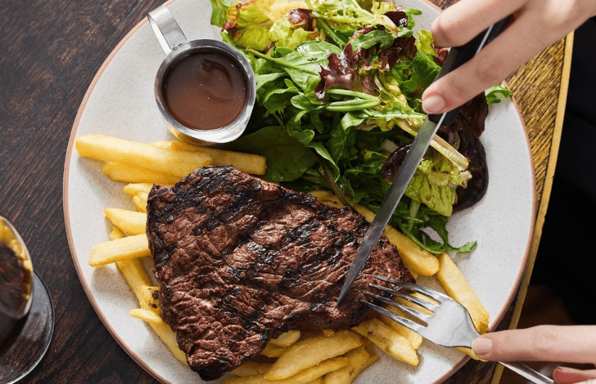 The picture of the steak with fries and salad
