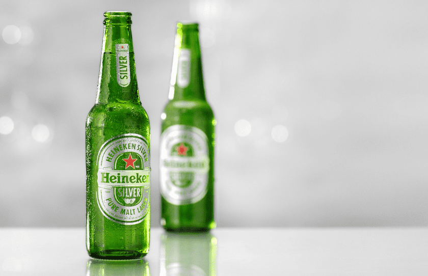 2 bottles of Heineken silver with a grey background