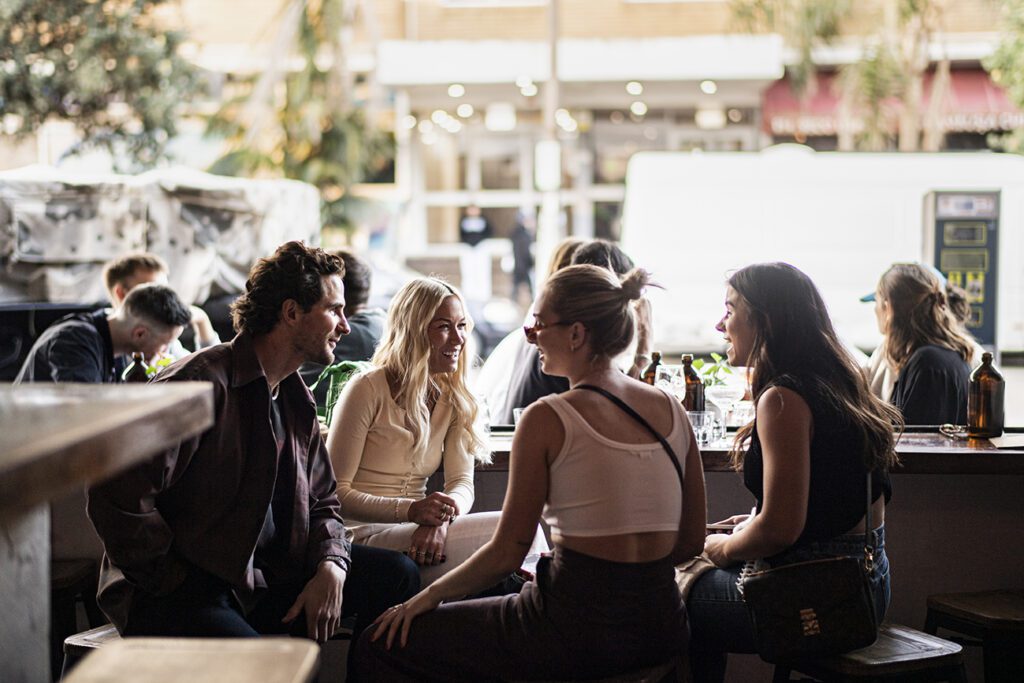 Neighbourhood Closure - Header - Group of girls drinking outside the venue