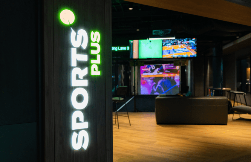 Sports Plus Immersive Experience - logo on sign as you enter and big screens in the back