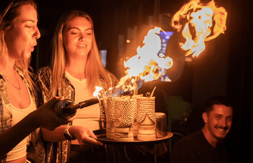 Bondi Neighbourhood Closing - Image of two female customers with cocktails that are on fire.