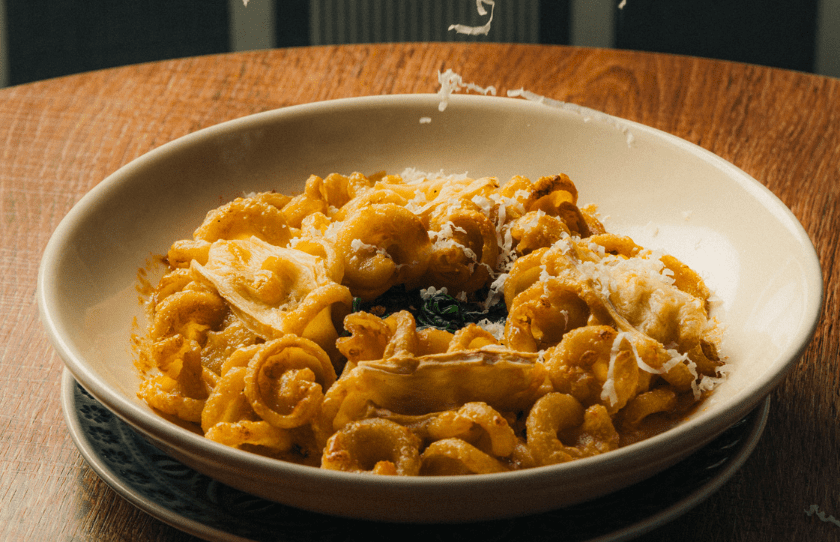 Pasta with cheese being sprinkled on top - Teddy Potts Point