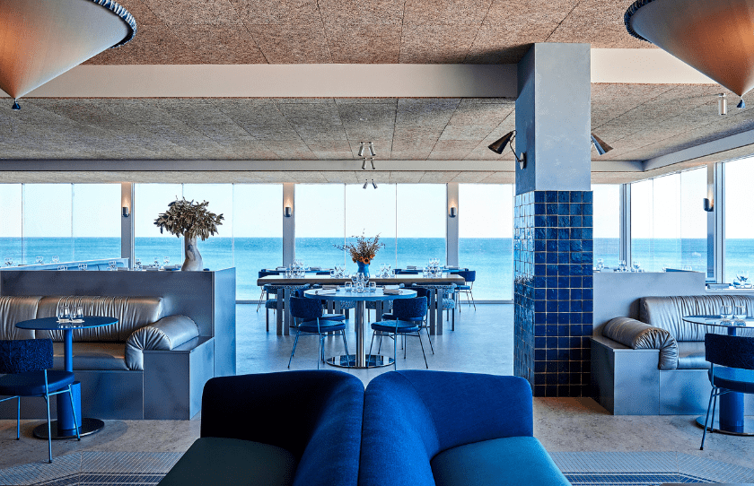 sea salt restaurant with all blue decor and the ocean in the background on Elouera Beach.