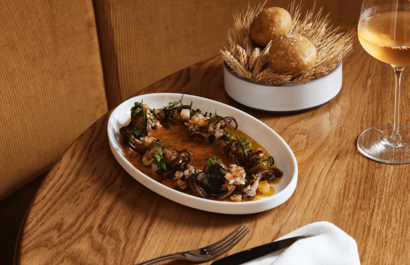 Parlar Potts Point Spanish Tapas - Dish with bread and cutlery on wooden table